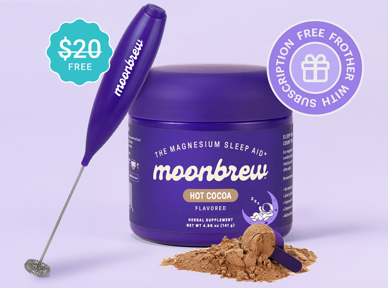 Front view of Moonbrew Hot Cocoa tub showcasing cocoa powder, scoop, and purple frother with promotional badges on a light purple background